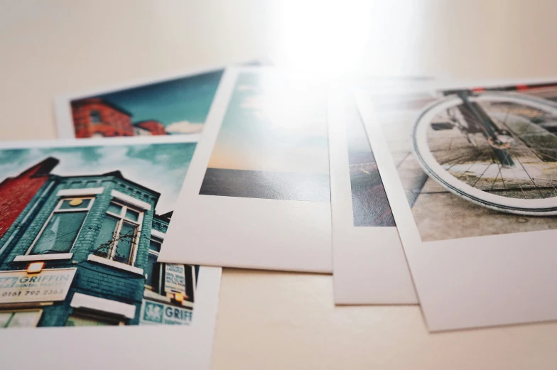 five pictures of bicycle wheel prints sitting on top of a table