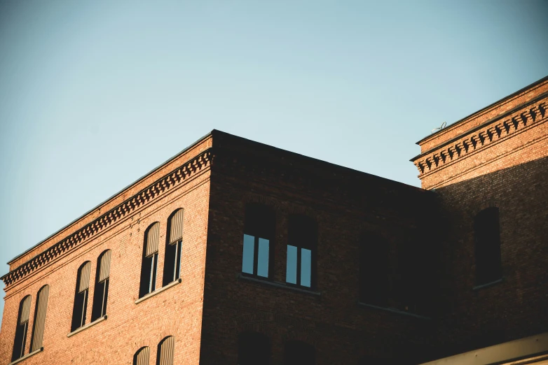 an industrial building is shown against the sky