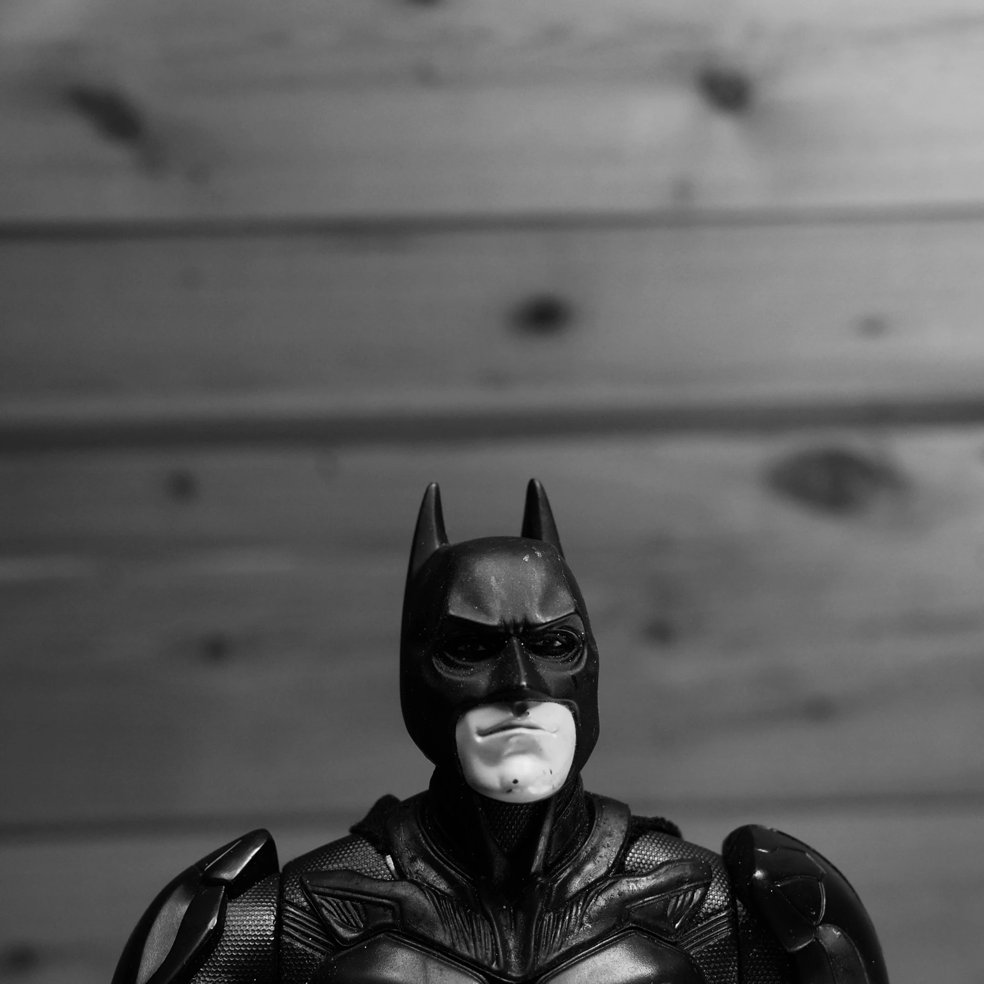 a po of a batman doll in a batman costume