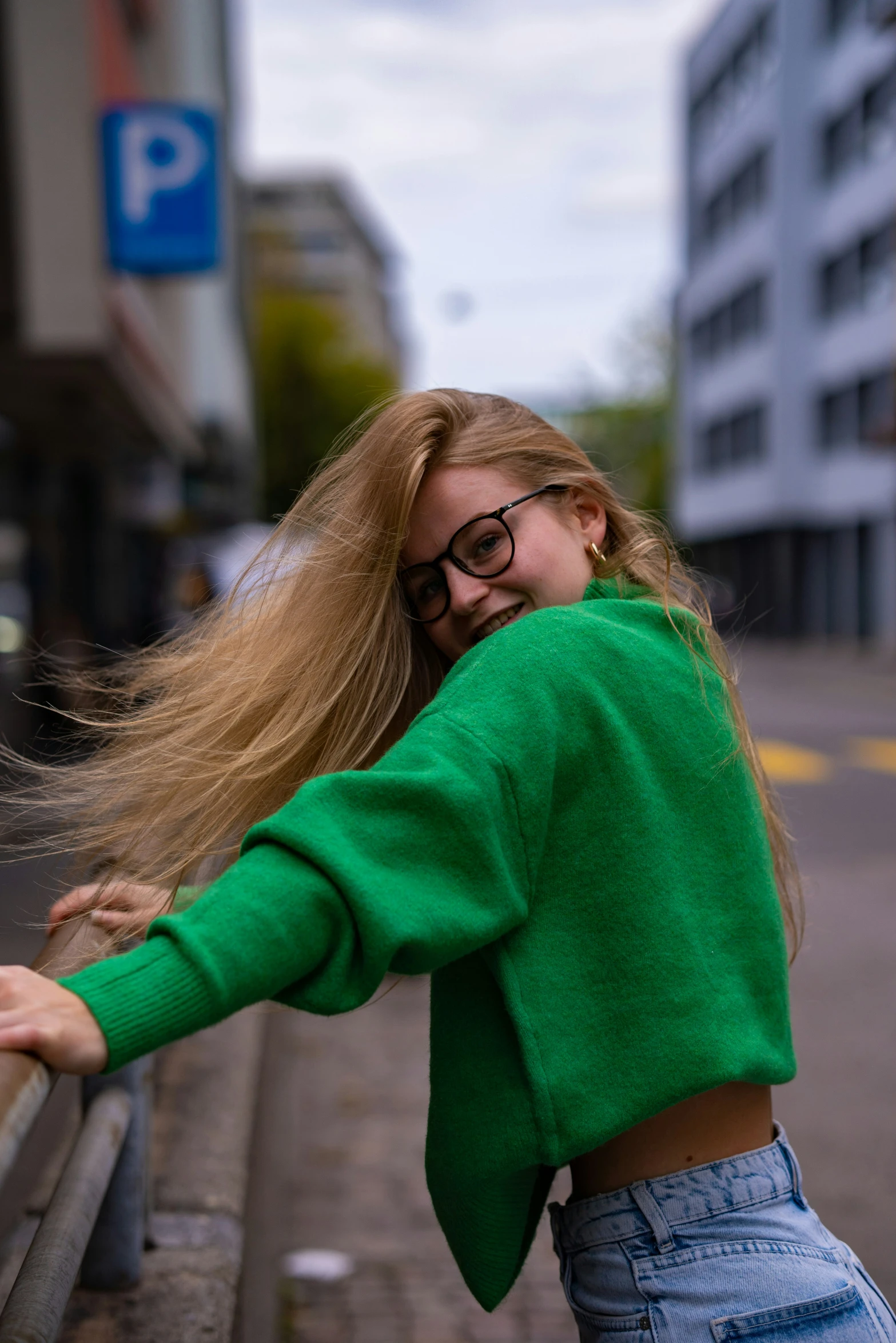 a beautiful woman leaning against a bench smiling