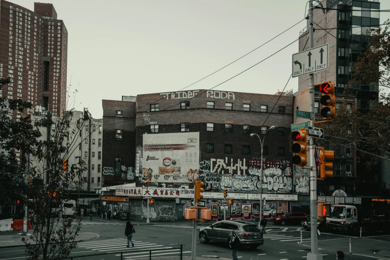 this intersection is surrounded by buildings with graffiti on them