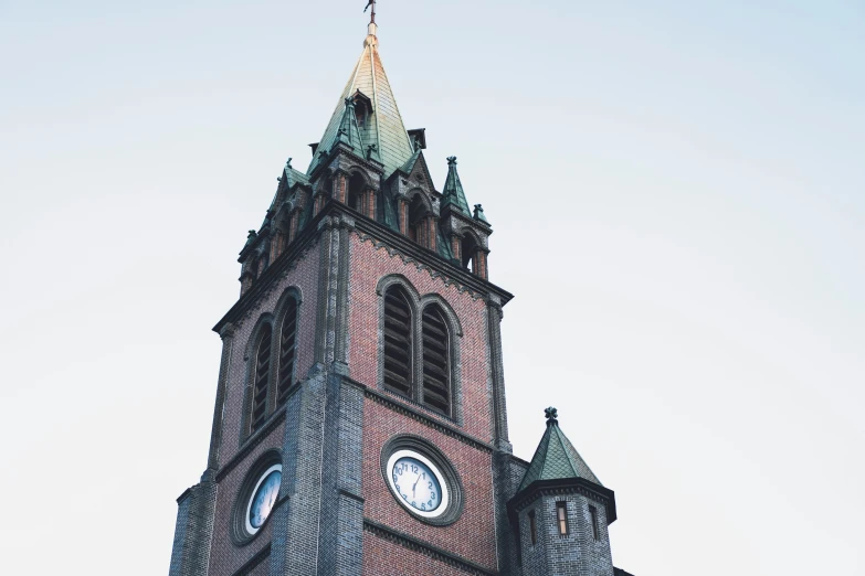 a very large tower with two clocks and a spire