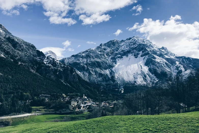 a view of a mountain range and grassy field