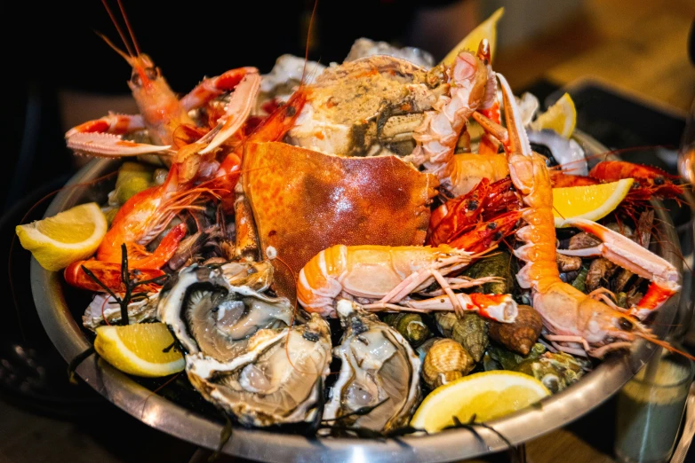 a bowl with various foods and seafood
