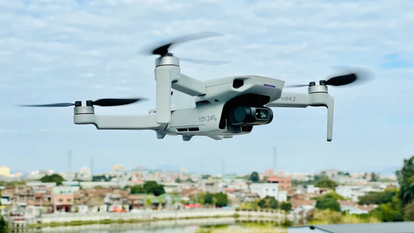 a white quad quadterd with an electronic camera and remote control