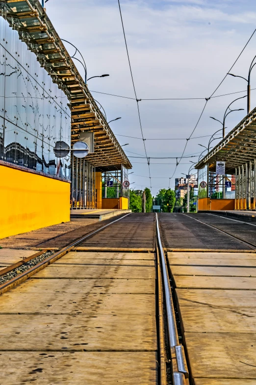 a row of yellow train tracks in a rail yard