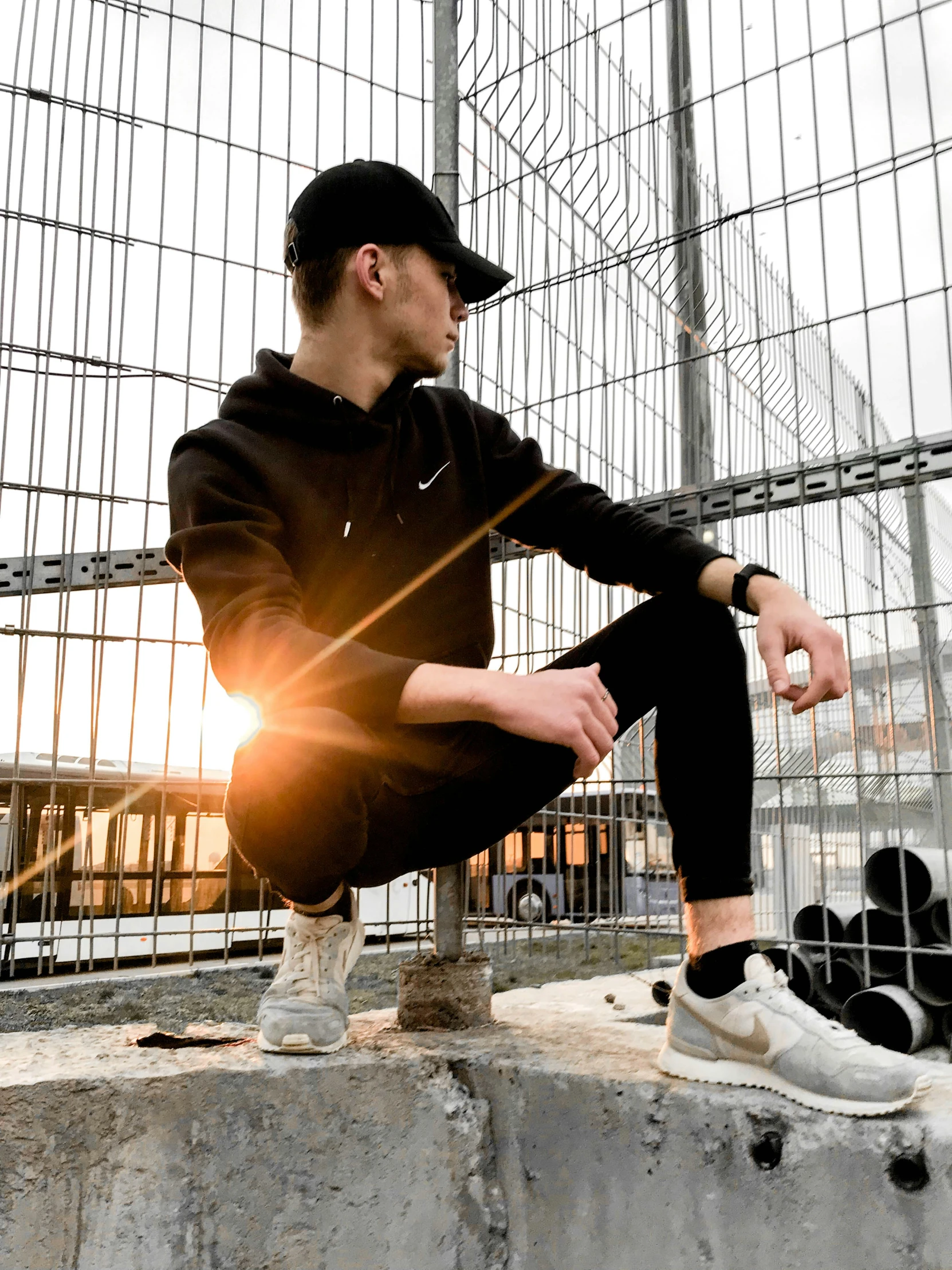 a young man sitting on top of a cement structure