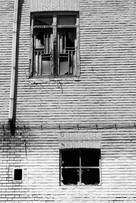 a person sitting on a bench in front of a window