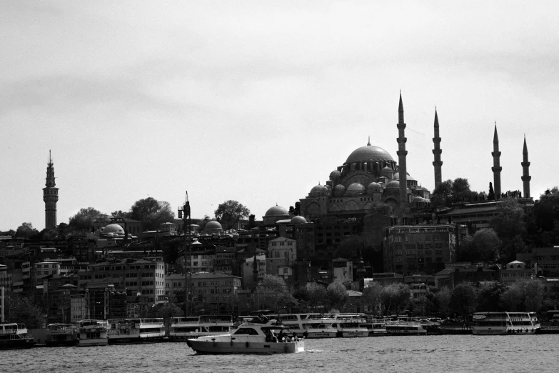 a boat traveling along a body of water near buildings