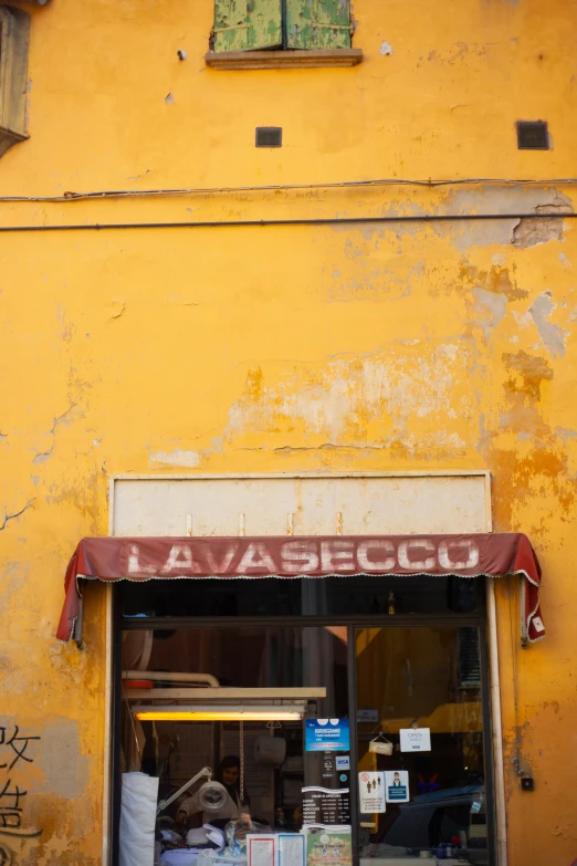 a person sits in a window of an old building