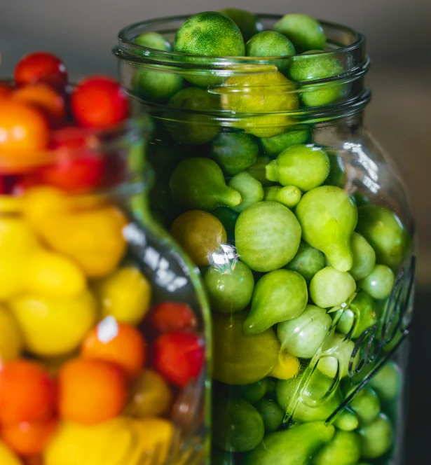 a lot of different colors of fruit in a jar