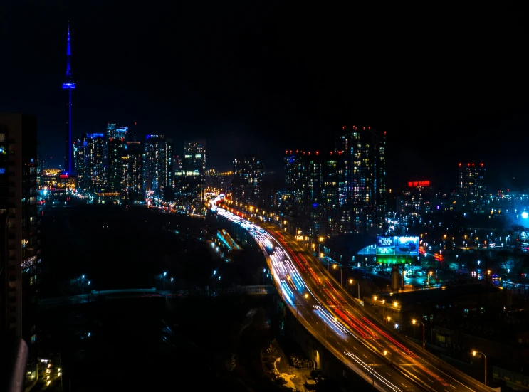 cars are traveling down a long highway at night