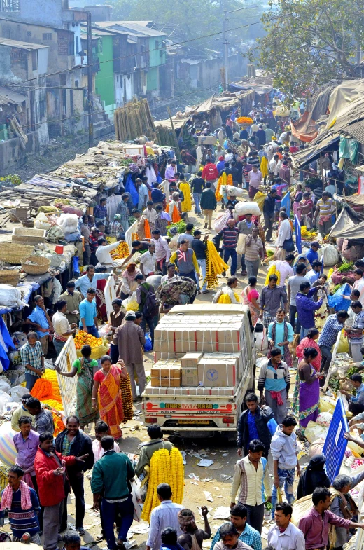 many people are walking around a crowded city street