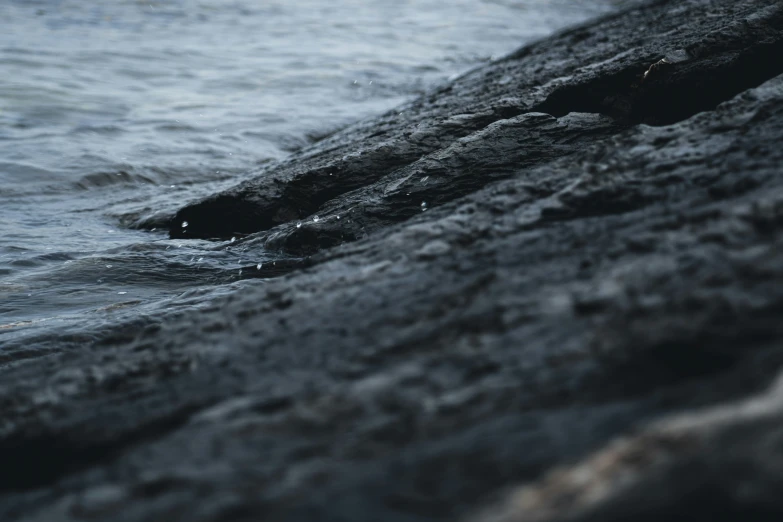 the water is running over the rocks at the beach