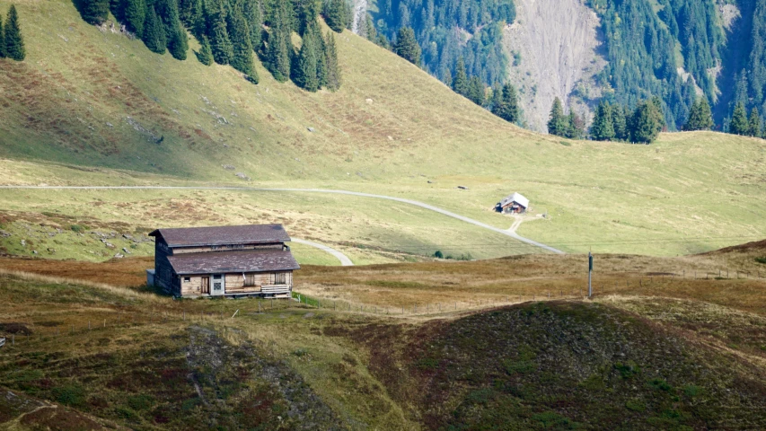 a farm house in the middle of a hilly valley