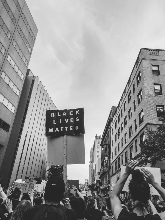 a large crowd watches the black lives matter rally