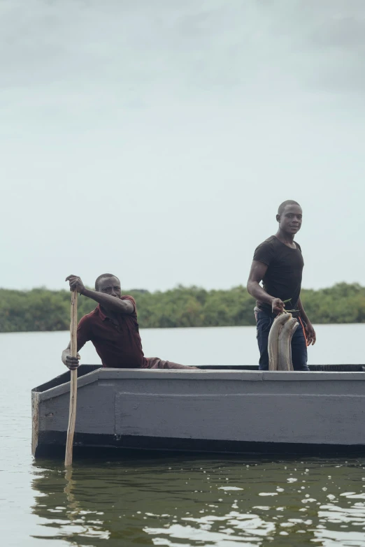 two men on a boat on the water