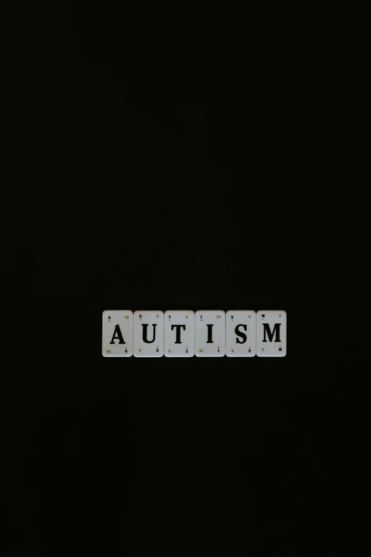 the word autism spelled in letter tiles