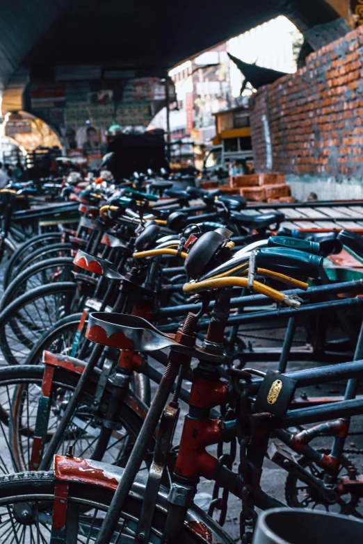 a row of bikes parked in a storage room