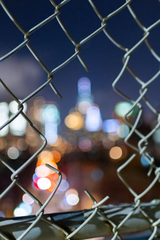 view of a city from behind the fence