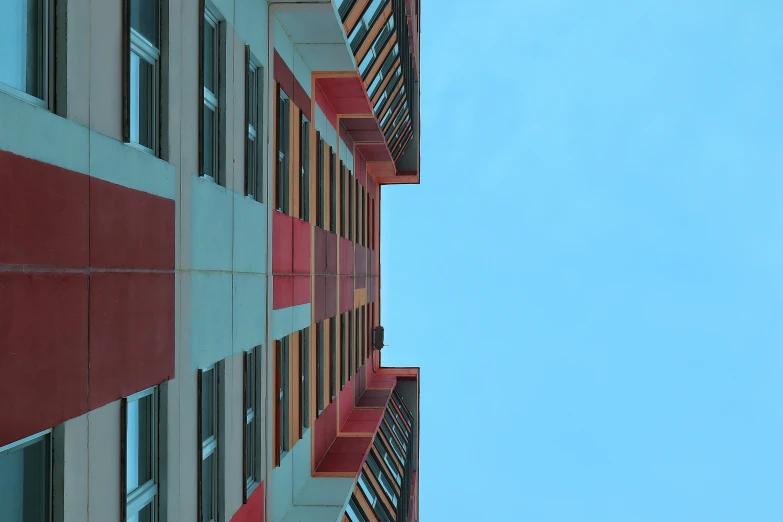 some windows on the outside of buildings against a blue sky