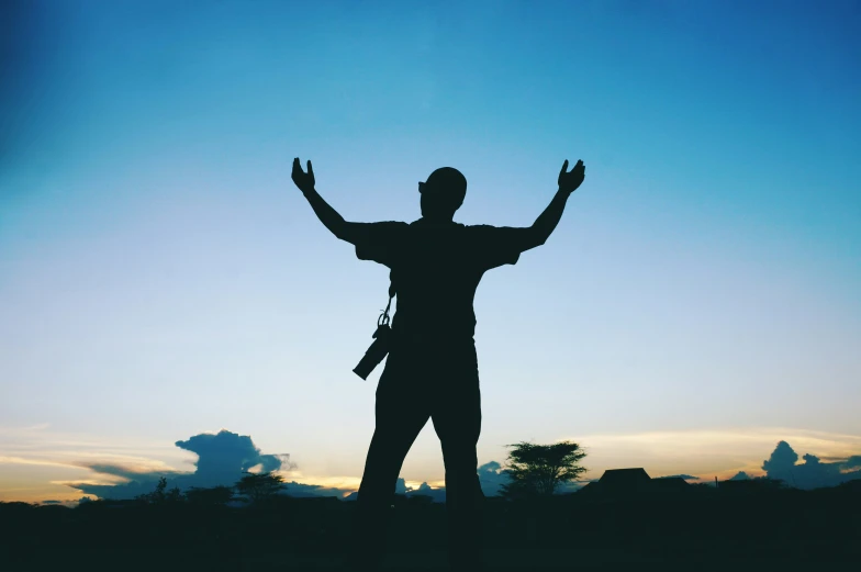 a person standing on top of a hill in the middle of the day