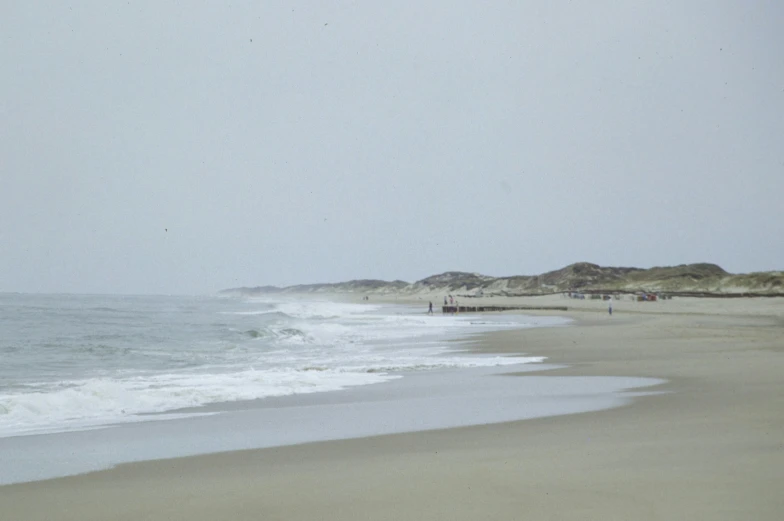 the surf is crashing onto the beach in the ocean