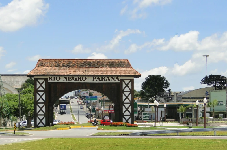 an arched entrance arch on the side of a road