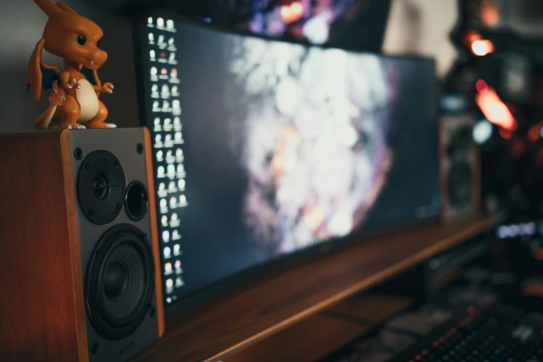 the keyboard, monitor and mouse are positioned beside the speakers