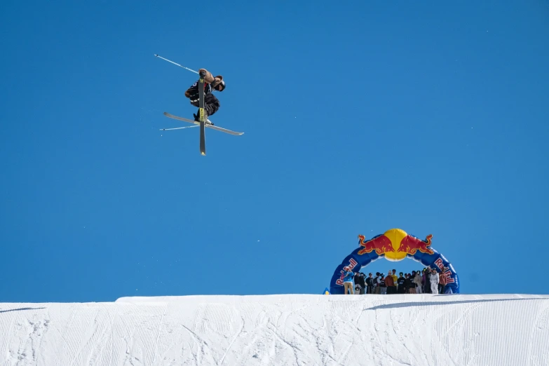 a person in the air on skis next to a sign