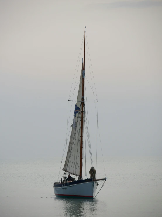 a sailboat floating in the water on a calm day