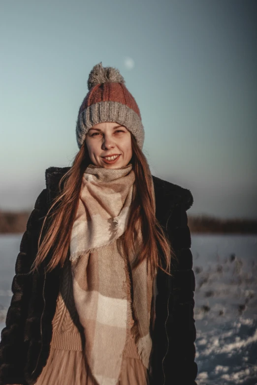 a pretty young lady wearing a hat and scarf