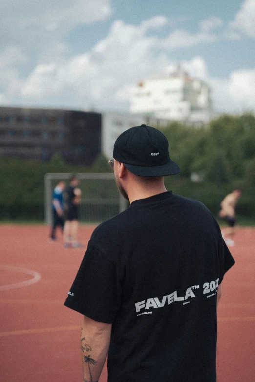 a man stands on a baseball field looking at the ball