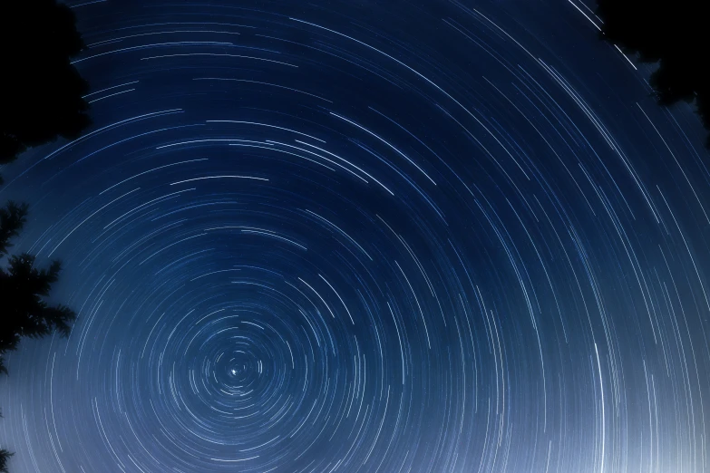 a view of a night sky with star trails