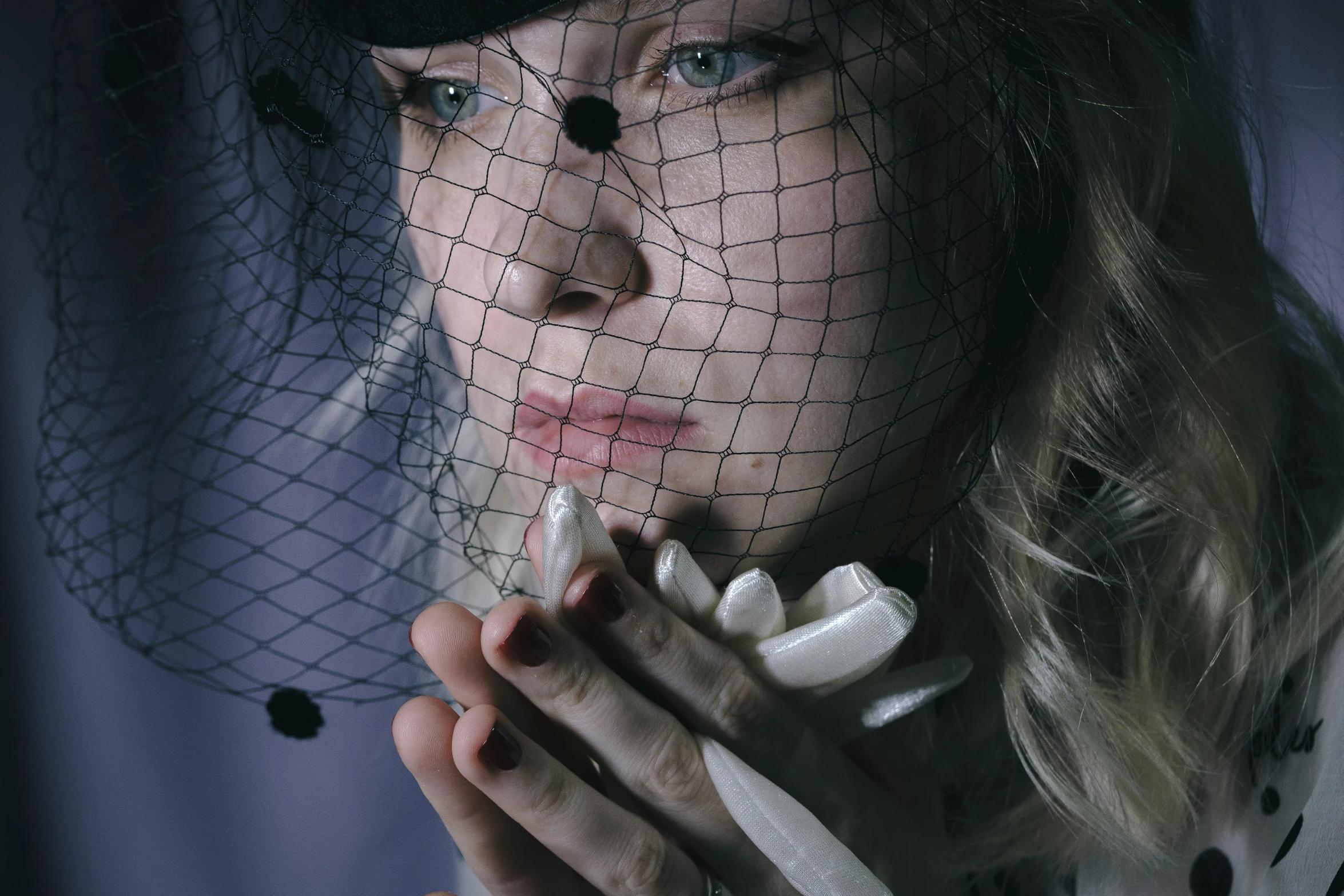 a girl wearing veil with hat in the background