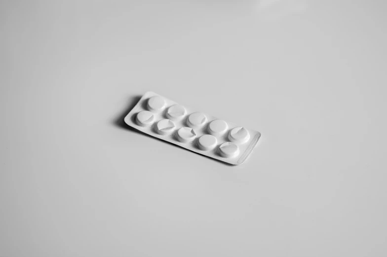 a pills pill case on a table with a spoon and orange