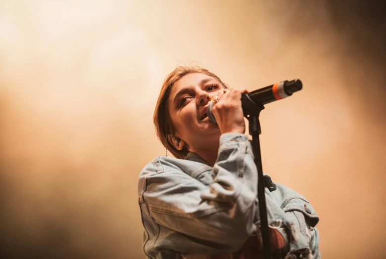 a woman holding a microphone up to her mouth