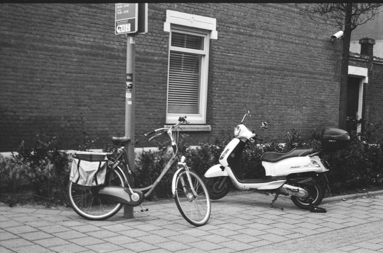 two bikes parked next to each other next to a wall