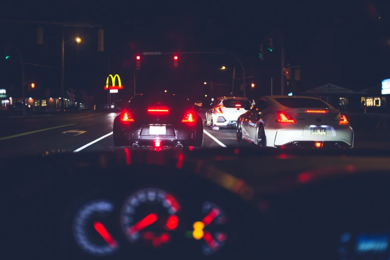 some cars lights and street signs at night