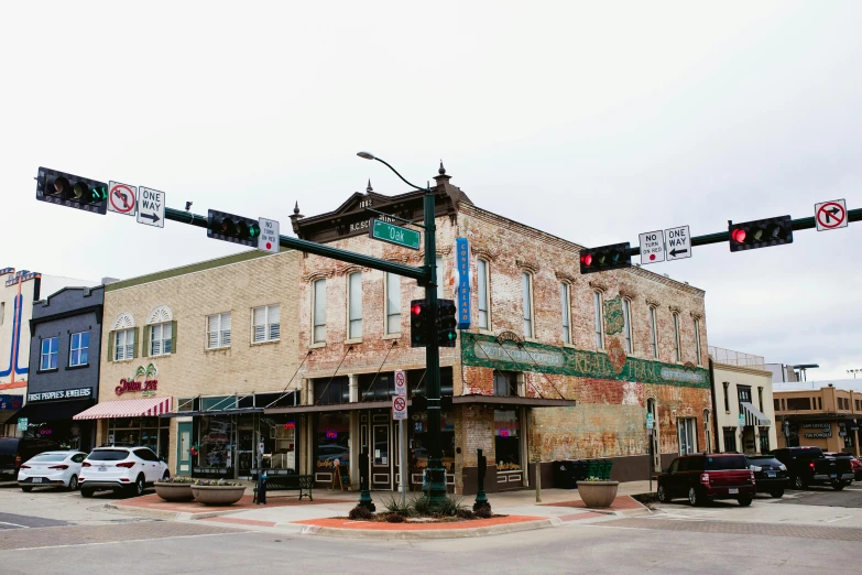 the corner building has traffic lights and street signs