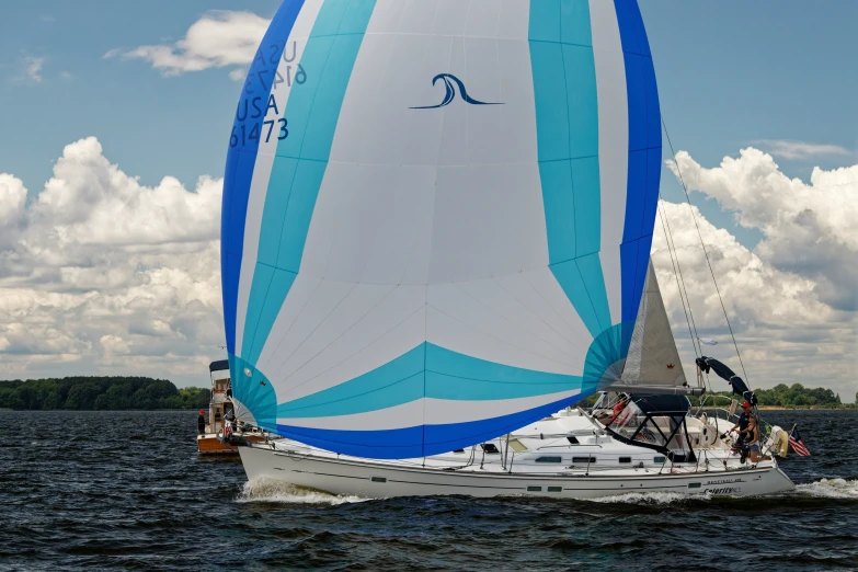 a sailboat with people in it is seen in the water