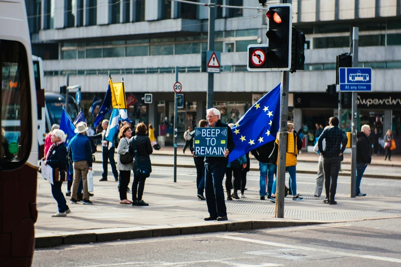 people on the street are holding flags and signs