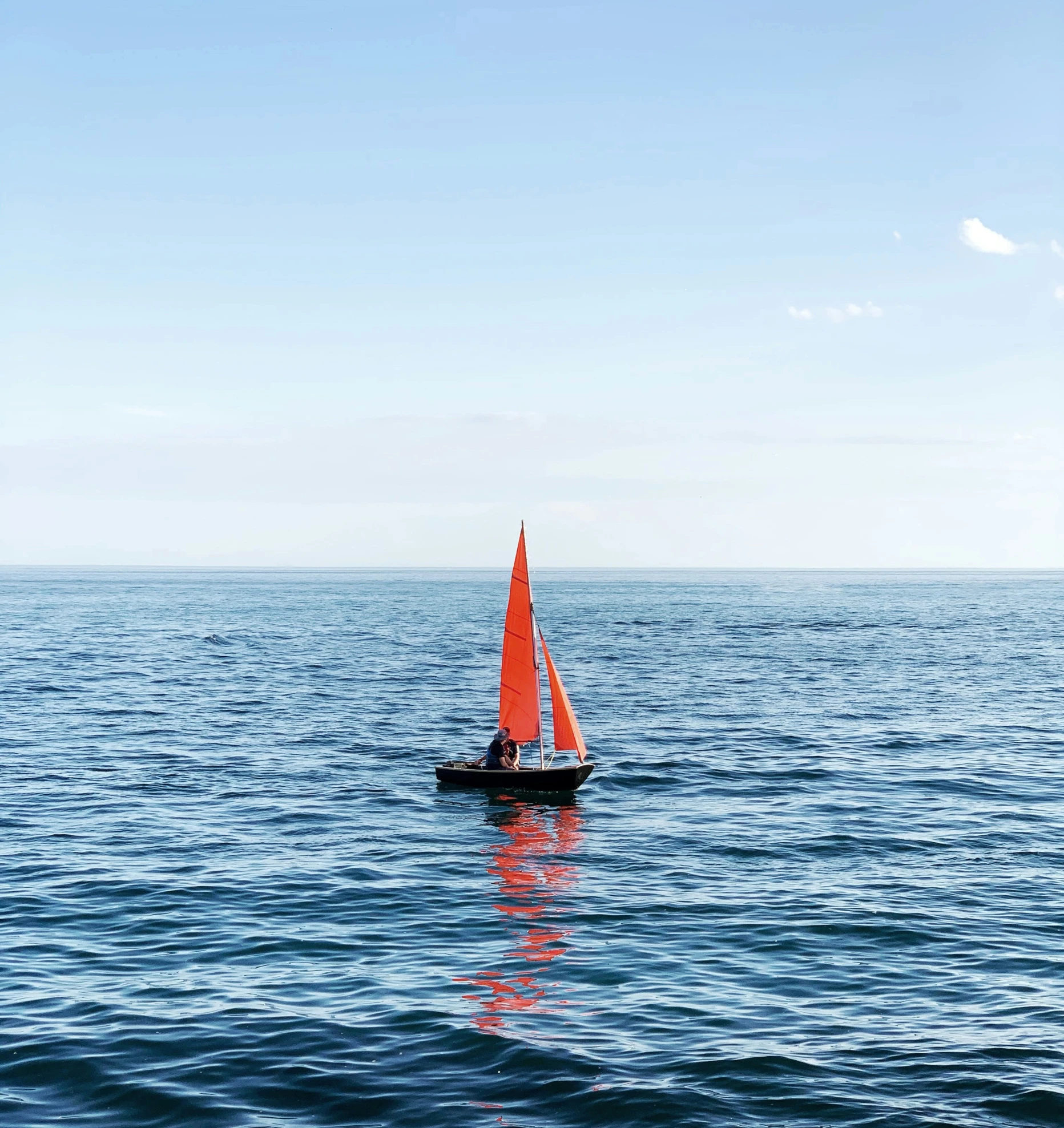 a small boat floating on top of a body of water