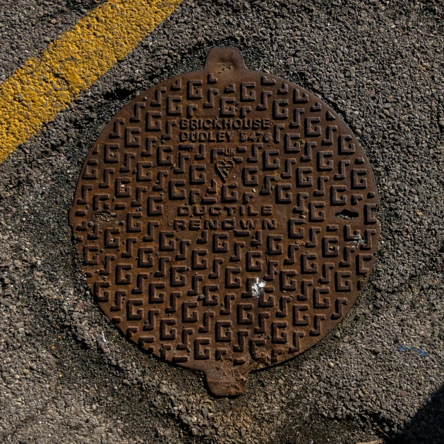 a manhole cover is shown on the sidewalk