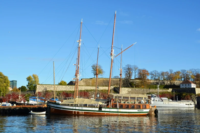 several small wooden sailboats are docked in a harbor