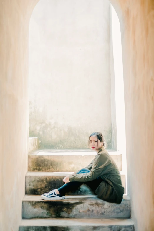 a woman sitting on steps with headphones on