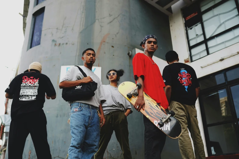 several young men holding skateboards standing on a step