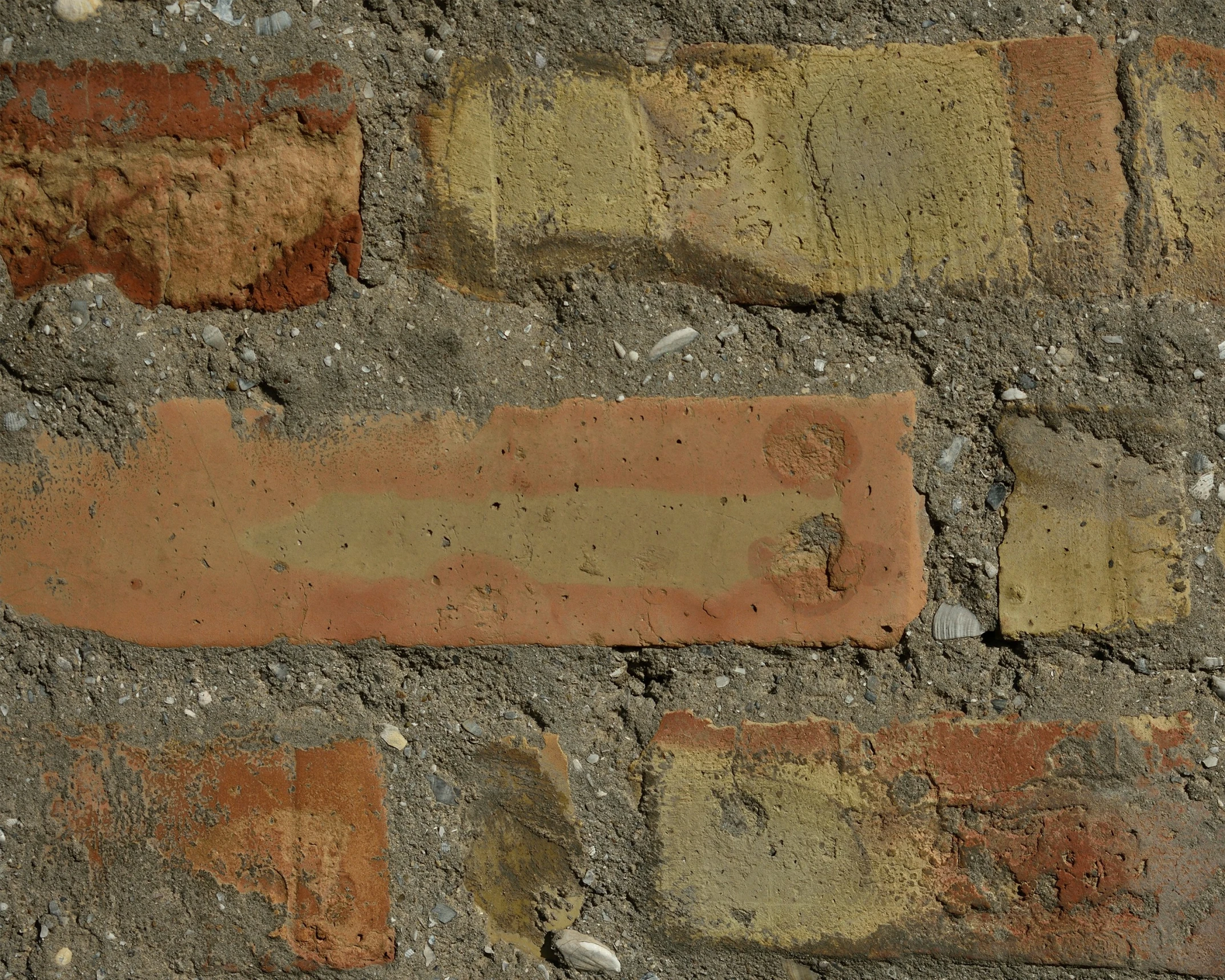 red bricks with yellow spots against a gray and tan background