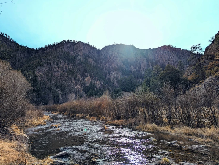 a body of water surrounded by brown hills