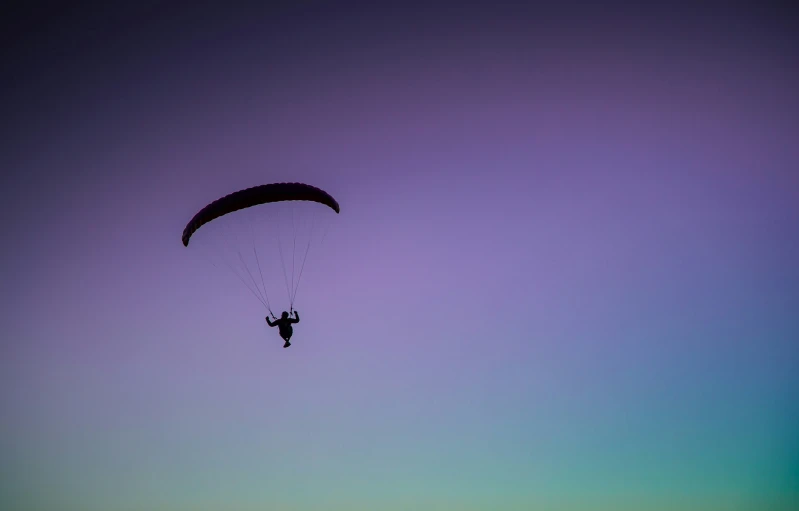 a parasailer gliding over an area that looks like it is very large